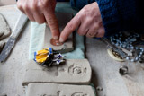 50. Imprinting an emblem into the clay
